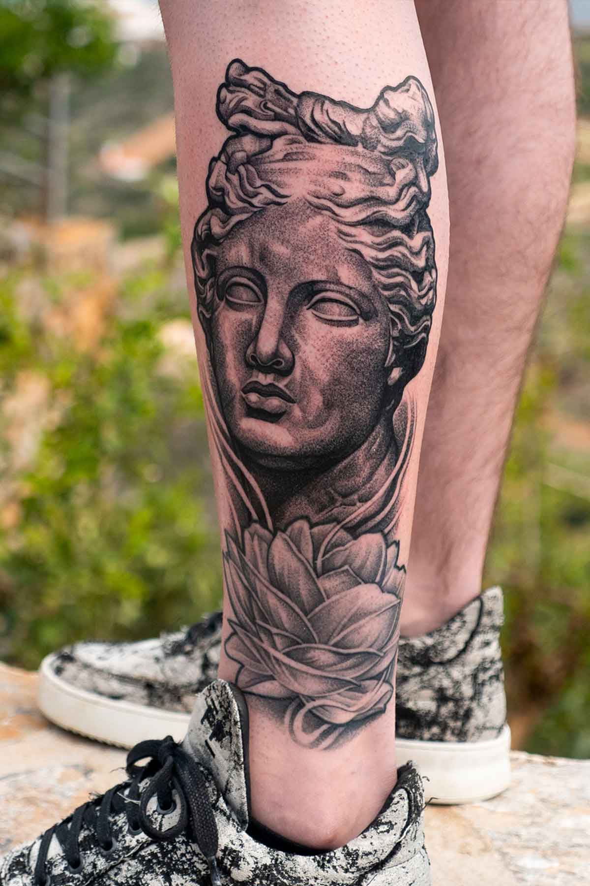 Realistic Leg Statue Tattoo by Dave Paulo